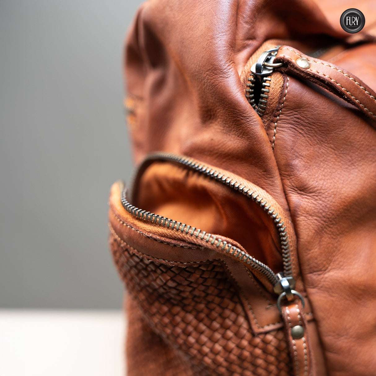 Multi-pocket backpack in woven leather