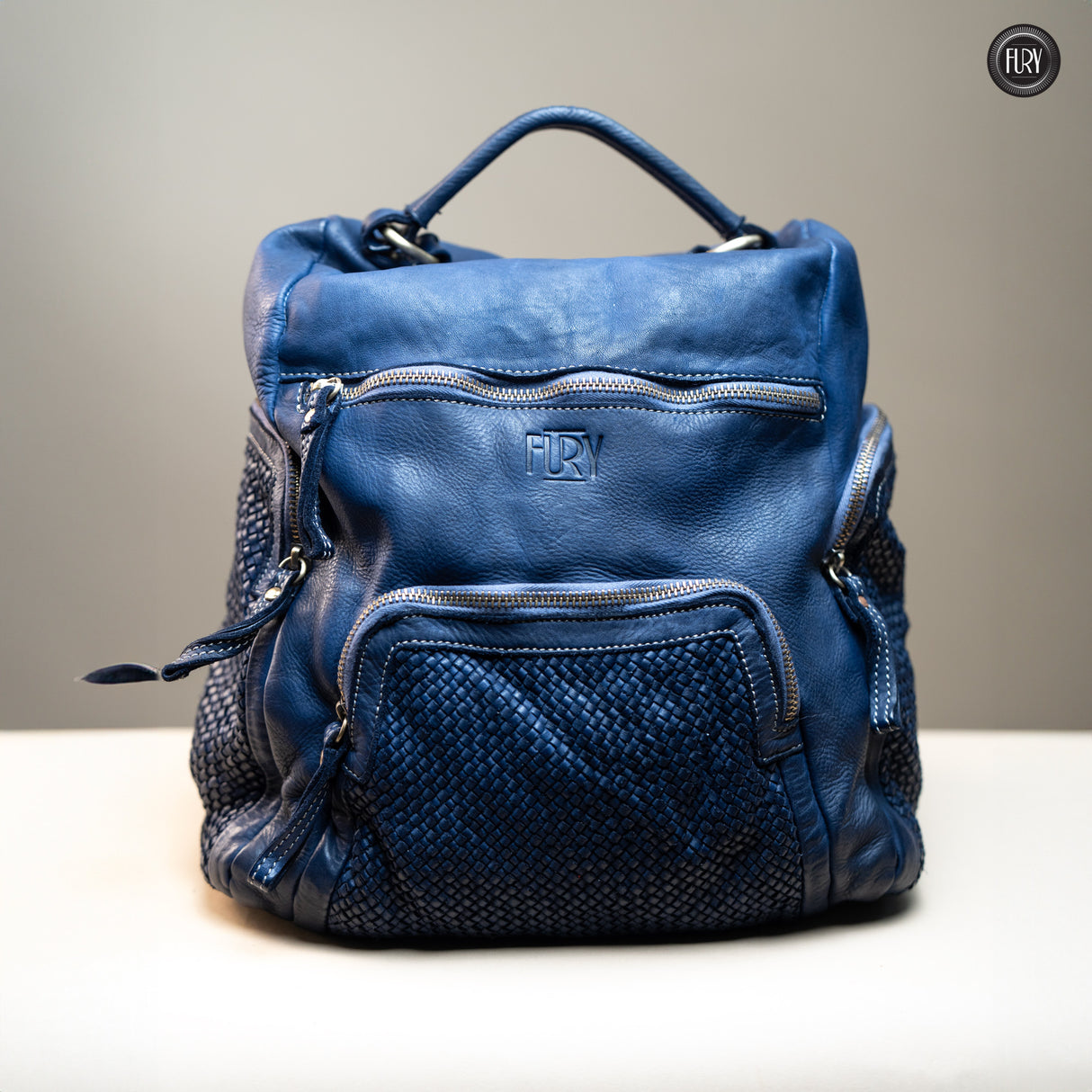 Multi-pocket backpack in woven leather